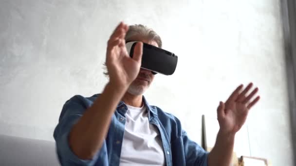 Чоловік у гарнітурі VR. Красивий чоловік, який відпочиває, використовує окуляри VR. Нові технології — стокове відео