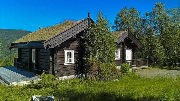 cottage in the mountains at the edge of the forest.