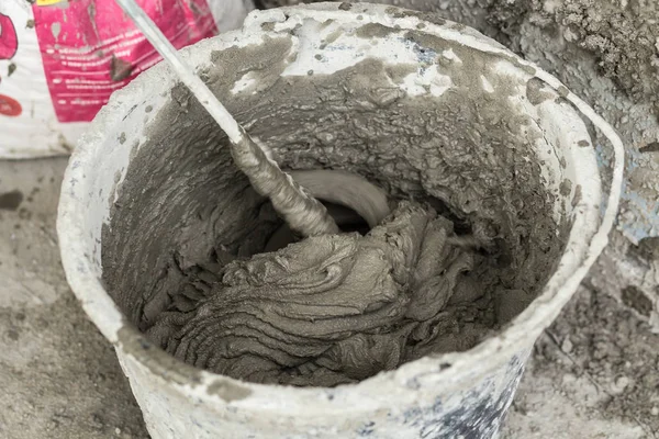 Concrete mixing with electrical drill and mixer. Wet Facade Insulation — Stock Image Concrete mixing with electrical drill and mixer. Wet Facade Insulation Stock Photo