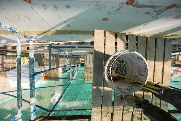 Top view on bucket with dowels on high-altitude scaffolding — Stock Photo, Image