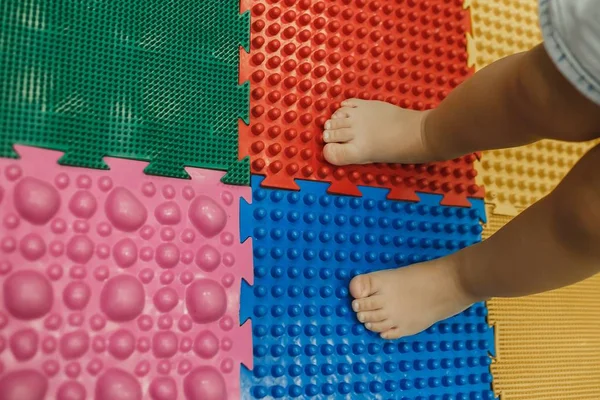 Pikkulapsi vauvan jalka hieronta matto. Harjoituksia jalat ortopedinen hieronta matto. Ortopediset hierontapalapelilattiamatot lasten kehittämiseen — kuvapankkivalokuva
