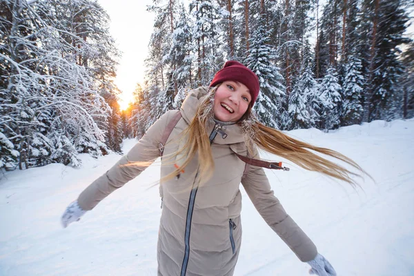 Young cheerful woman having fun winter in snow covered winter pine forest. Snowy weather. Big pines. Winter holidays — Stock Photo, Image