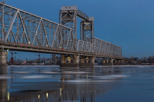Beautiful view of ice drift under the railway bridge in Arkhangelsk, Russia. Beautiful ice motion on Northern Dvina river, evening landscape — Stock Image Beautiful view of ice drift under the railway bridge in Arkhangelsk, Russia. Beautiful ice motion on Northern Dvina river, evening landscape Stock Picture
