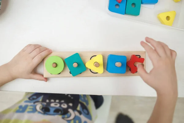 Niños jugando juegos educativos multicolores, mosaico y mesa de puzzles —  Fotos de Stock