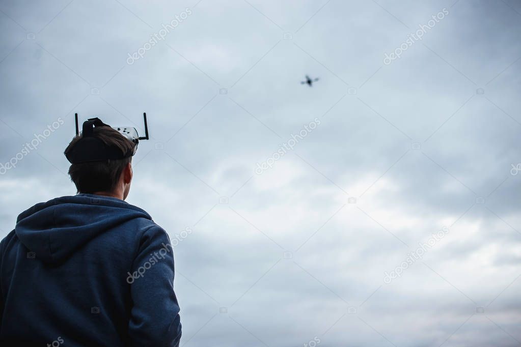 Man controlling custom made dron by virtual reality glasses