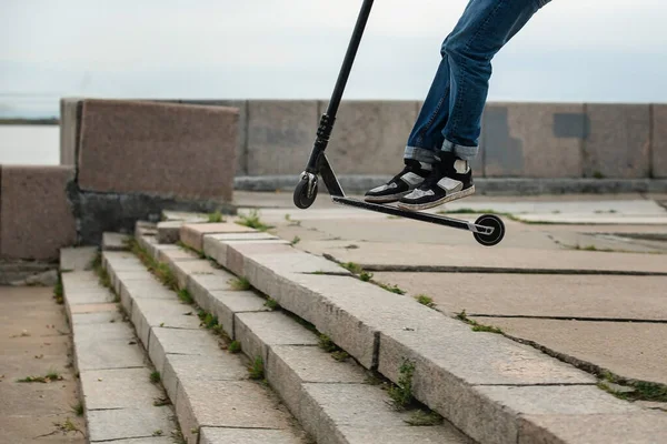 Junge auf Roller macht einen Trick und genießt seine Fahrt mit Skate in der Stadt Straße — Stockfoto