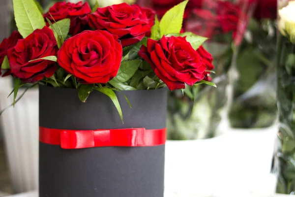 Beautiful bouquet of roses in a gift box. Bouquet of red roses. Red roses close-up