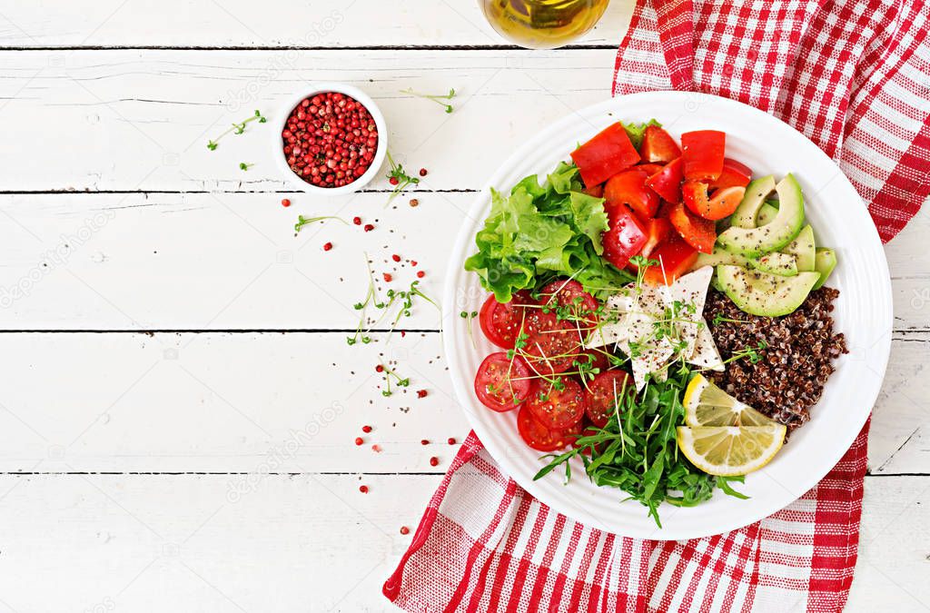 Vegetarian Buddha bowl with quinoa, tofu cheese and fresh vegetables. Healthy food concept. Vegan salad. Top view.