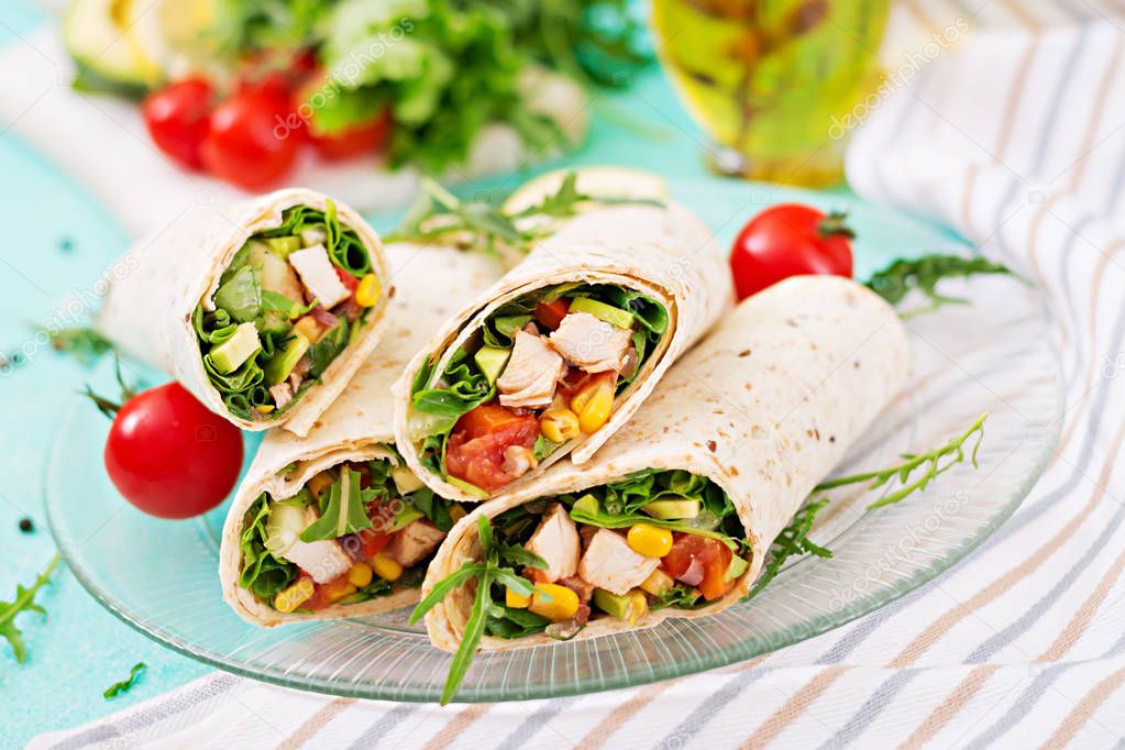 Burritos wraps with chicken and vegetables on light  background. Chicken burrito, mexican food.