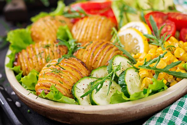 Vegetarian buddha bowl. Raw vegetables and baked potatoes in  bowl. Vegan meal. Healthy and detox food concept.