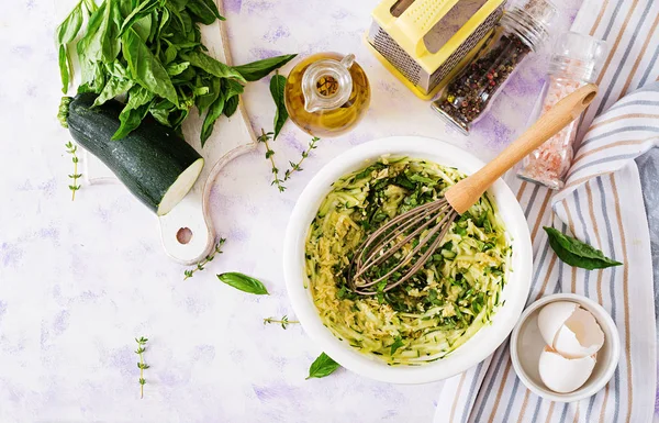 Ingredients for cooking frittata with zucchini, cheese and basil. Useful breakfast. Italian omelette. Top view. Flat lay.