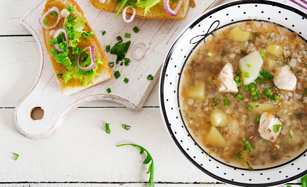 Buckwheat soup with chicken in a plate, bread with mustard ang red onion on a wooden white table. Top view — Stock Image Buckwheat Soup Chicken Plate Bread Mustard Ang Red Onion Wooden Stock Picture