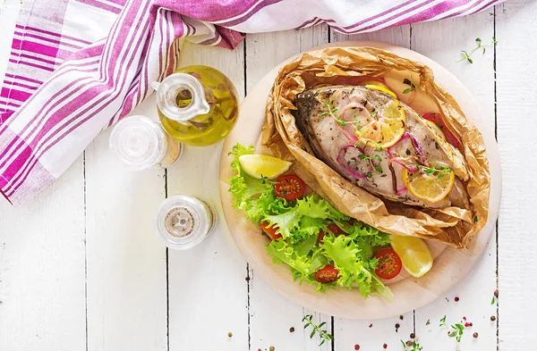 White fish steak (carp) baked in parchment paper with vegetables. Fish dish. Top view — Stock Image White Fish Steak Carp Baked Parchment Paper Vegetables Fish Dish Royalty Free Stock Photos