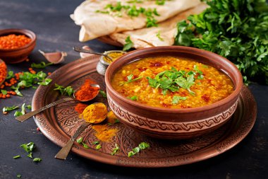 Hint dal. Geleneksel Hint çorbası mercimek. Hint Dhal baharatlı köri kase, baharatlar, bitkiler, rustik siyah ahşap arka plan. Otantik Hint yemeği. Ek yük