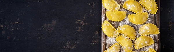 Uncooked ravioli on table. Italian cuisine. Top view — Stock Photo, Image