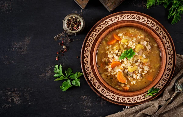 Barley soup with carrots, tomato, celery and meat on a dark background. Top view. — Stock Image Barley Soup Carrots Tomato Celery Meat Dark Background Top View Stock Image