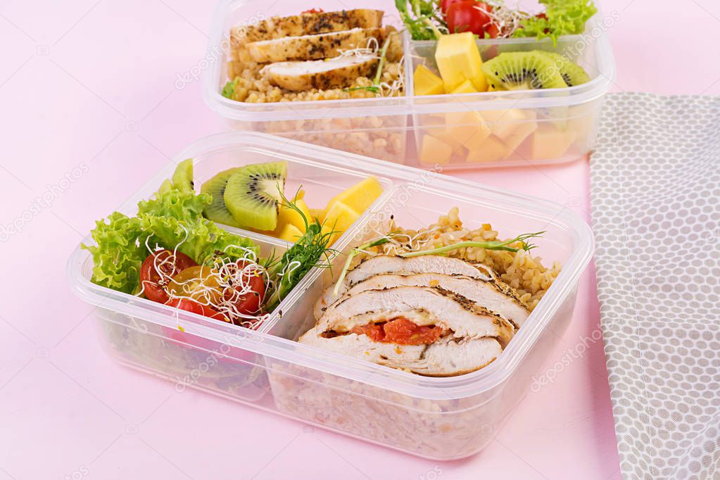 Lunch box  chicken, bulgur, microgreens, tomato  and fruit. Healthy fitness food. Take away. Lunchbox.