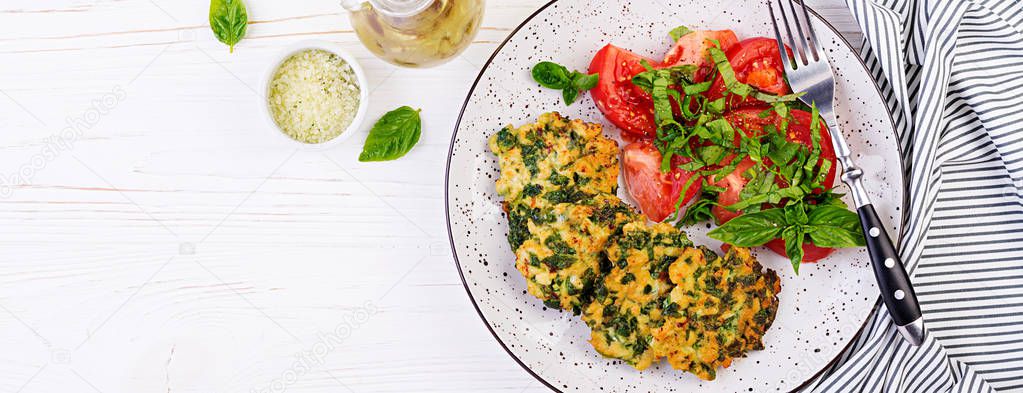 Baked steak chopped chicken fillet with spinach and a side dish of tomatoes salad. European cuisine. Dietary food.  Banner. Top view