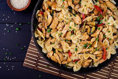 Tavada tavuk, makarna farfalle, kabak, tatlı biber ve yeşil soğan karıştırın. Üst te. Asya mutfağı