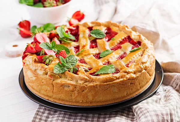 American strawberry pie tart cake sweet baked pastry food on white wooden table.