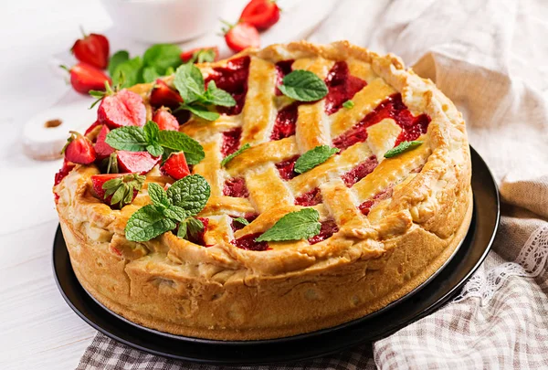 American strawberry pie tart cake sweet baked pastry food on white wooden table.