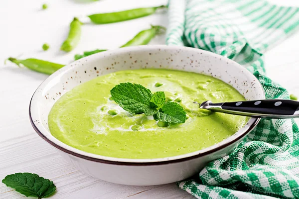 Green pea soup in bowl on wooden table. French cuisine. — Stock Image Green Pea Soup Bowl Wooden Table French Cuisine Stock Photo