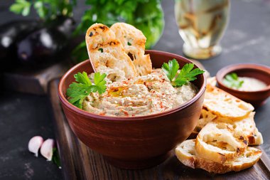 Baba ghanoush vegan hummus from eggplant with seasoning, parsley and toasts. Baba ganoush. Middle Eastern cuisine. clipart