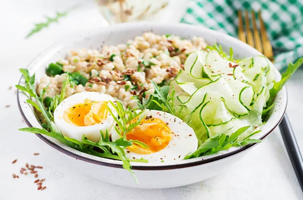 早餐燕麦粥配绿草 煮熟的鸡蛋 黄瓜和亚麻籽 健康均衡的食物 — 图库照片