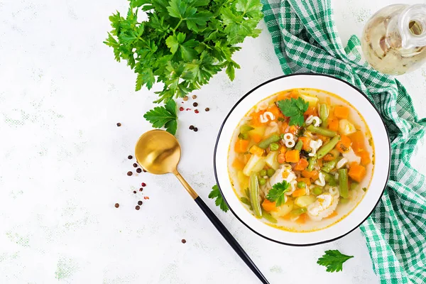 Minestrone, italian vegetable soup with pasta on light table. Top view, flat lay, copy space — Stock Image Minestrone Italian Vegetable Soup Pasta Light Table Top View Flat Royalty Free Stock Photos