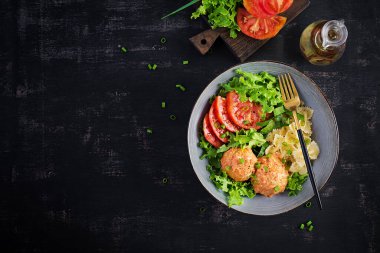 İtalyan makarnası. Köfteli Farfalle ve arka planda salata. Akşam yemeği. Üst manzara, genel giderler. Yavaş yemek konsepti