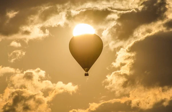 The balloon flies against the background of the sun