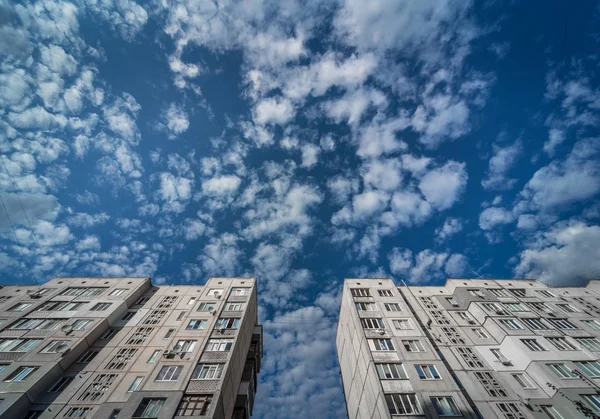 Apartment building on a background of sky with clouds