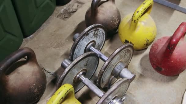 Dumbbells and kettlebells in close-up — Stock Video