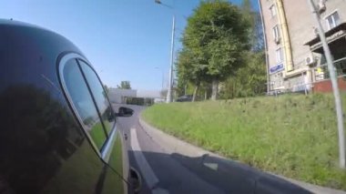 Semt güneşli yaz gününde cadde boyunca araba taşır. Araba vücut yan görünüm.