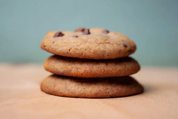 stack of chocolate chip cookies on blue background