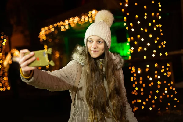 クリスマス マーケットで Selfie を取って長い髪の美しいティーンエイ ジャー ロイヤリティフリーのストック画像