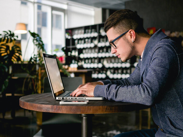 business man with laptop in cafe