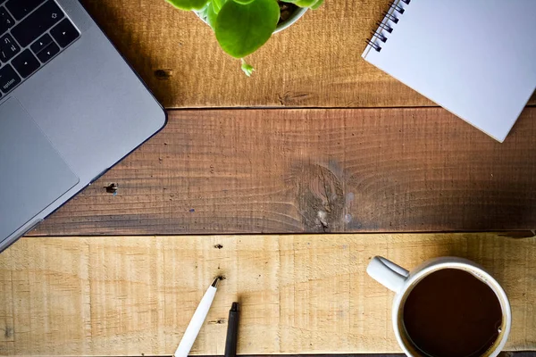 Coffee cup hot and laptop notebook on wooden table desk