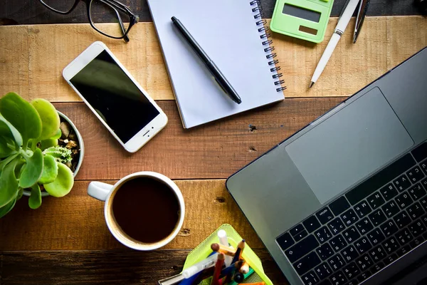 Coffee cup hot and laptop notebook pen on wooden table desk