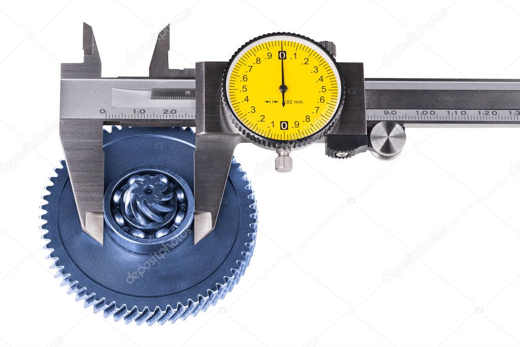 Measurement of cogwheel diameter by caliper. Isolated on white background