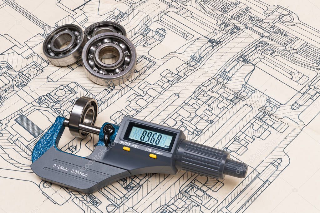 Micrometer screw gauge. Ball bearings. Drawing on background