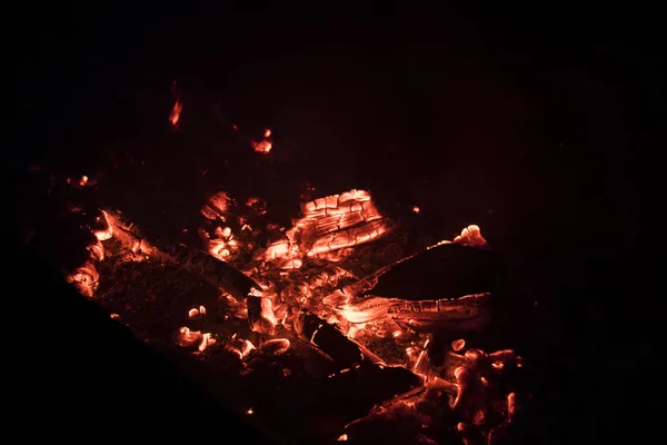 Hot embers from a campfire at night. Can be used for background and texture.    Fire at night. Fire red and orange embers.
