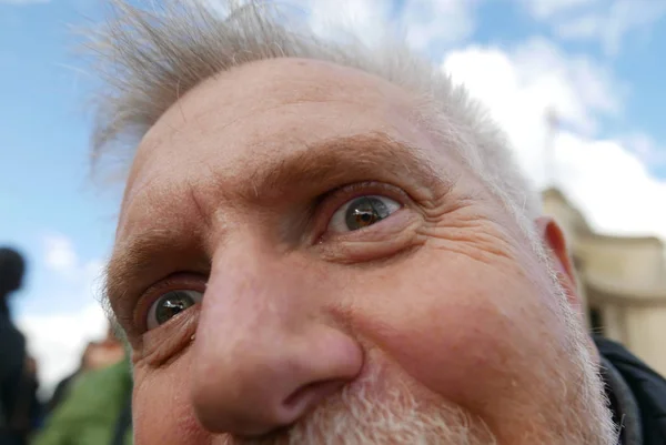 Funny mature man with Eiffel Tower reflection in the eyes