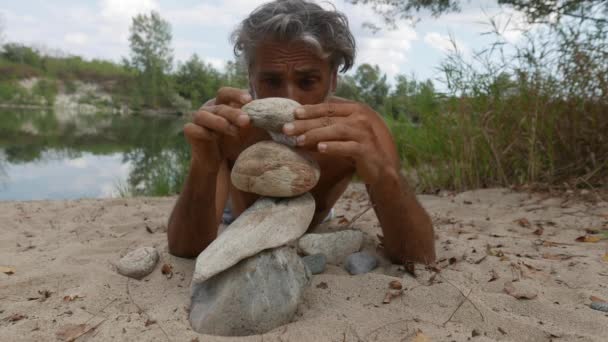 Man Doing Stone Piles River — Stock Video
