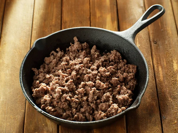 browned ground beef in cast iron skillet