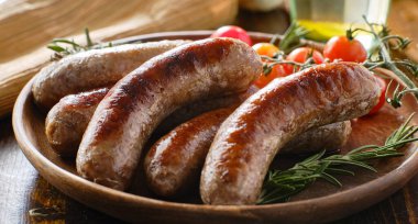 plate of german bratwurst sausages with herbs clipart