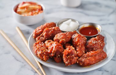 Gochujang soslu Kore tavuk kanadı ve turp turşusu.