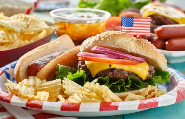 4 Temmuz temalı hamburger ve kağıt tabakta sosisli.