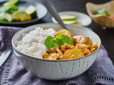 thai massaman chicken curry in bowl with jasmine rice clipart