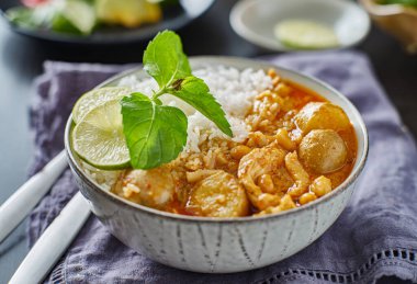 thai massaman chicken curry in bowl with jasmine rice clipart